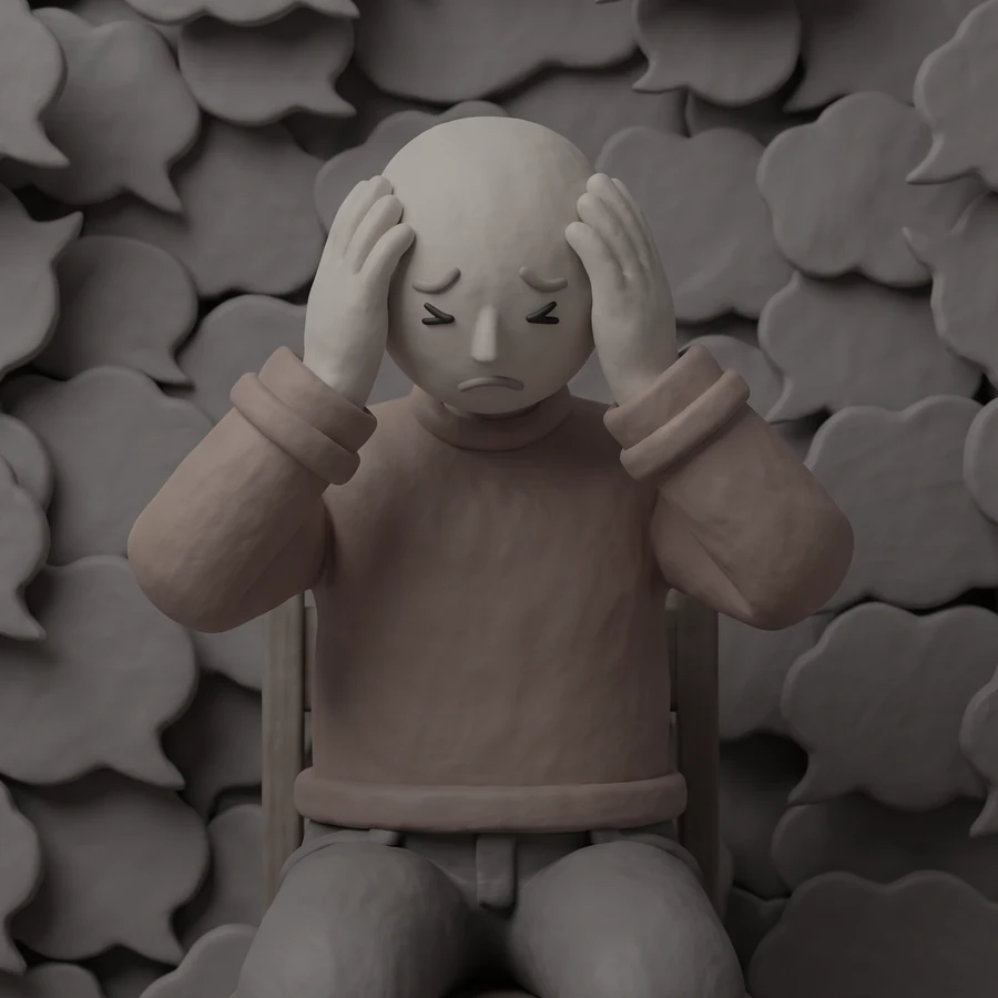 A clay figure surrounded by thought bubbles, head bowed, both hands pressed to his temples